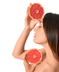 Naked young woman with cut grapefruit on white background. Vegan Day