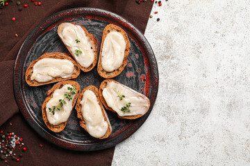 Plate of bread with lard spread on light background