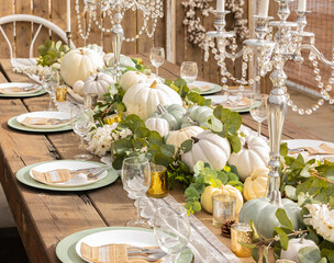 Autumn and Thanksgiving table decoration with white mini pumpkins