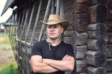 Cowboy in a hat and a black t-shirt.