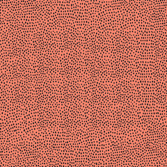 Seamless vector spots pattern. Animals small splash blots pattern on orange background. Abstract background.