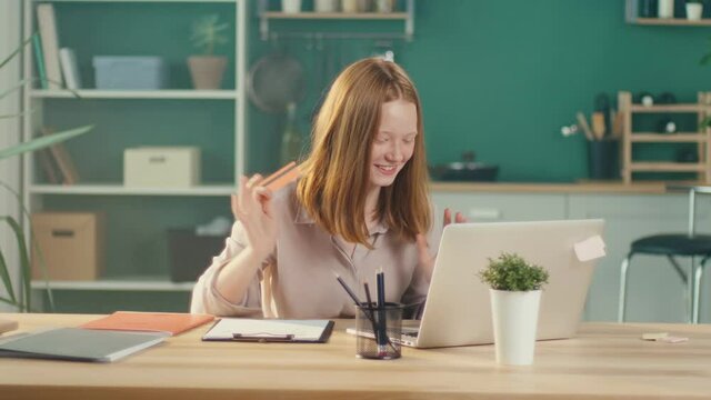 Happy Red-haired Teen Girl Shopping Online with a Card From Home. Consumer, Easy Shopping, Discounts, Online Shopping. Earlier Financial Development.