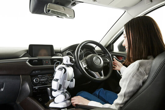 ロボットを使って自動運転車を操作する女性