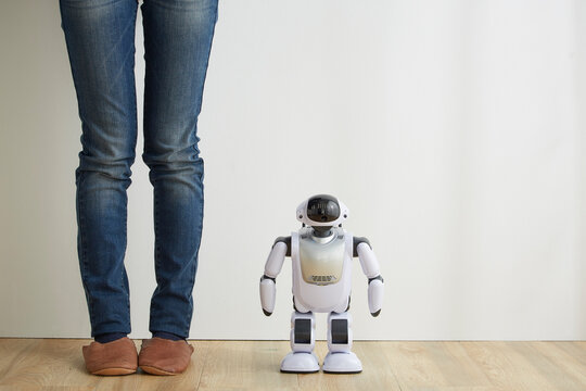 立っている女性の足とロボット