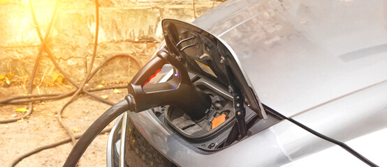 Plugged charger into an electric car banner photo
