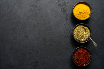 Set of spices : turmeric, saffron and dried thyme. Top view with copy space.