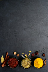 Obraz na płótnie Canvas Set of spices : turmeric, saffron , dried thyme, cinnamon, nutmeg, anise. Top view with copy space.
