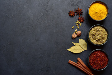 Set of spices : turmeric, saffron , dried thyme, cinnamon, nutmeg, anise. Top view with copy space.