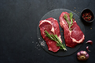 Raw organic rib eye steak with ingredients for making. Top view with copy space.