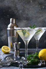Cold lemon martini with rosemary in a glasses.