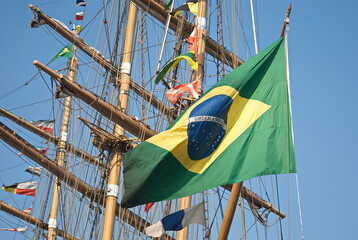 Sailing ship with many little flags and big Brazilian flag. 