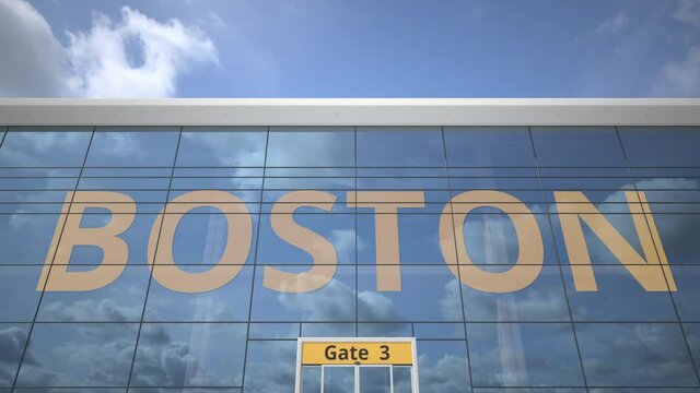 Commercial airplane reflecting in airport terminal with BOSTON text