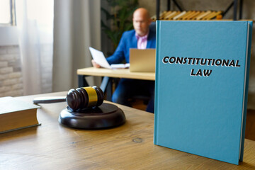  CONSTITUTIONAL LAW inscription on the sheet. Constitutional law, the body of rules, doctrines, and practices that govern the operation of political communities - obrazy, fototapety, plakaty