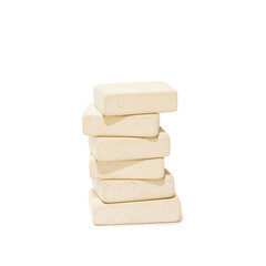 Stack of uniform stationery erasers on white isolated background