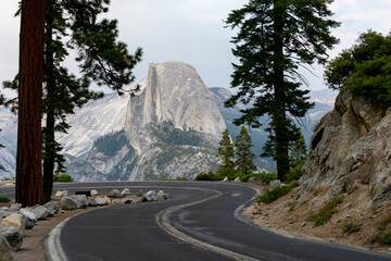 Landscape of the Glacier Point Road surrounded by rocky hills in Yosemite National Park, California