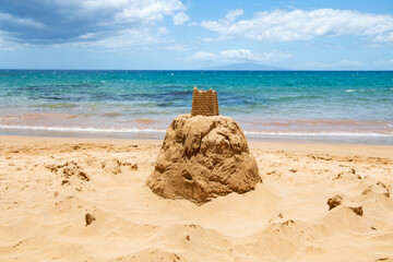 Sand castle. Tropical beach with sea sand on summer vacation.