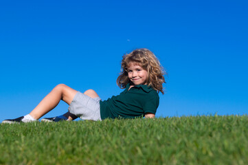 Child boy relax outdoors in sunny summer day.