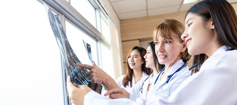 Senior Doctor Woman Teaching Doctor Student Woman. How To Analyze The X-ray Film. Radiology Department.