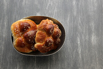 Delicious, fluffy and freshly made at home pan de muerto with sesame seeds sprinkled as a Mexican tradition for the Day of All Souls and All Saints which is celebrated in November
