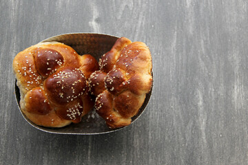 Delicious, fluffy and freshly made at home pan de muerto with sesame seeds sprinkled as a Mexican tradition for the Day of All Souls and All Saints which is celebrated in November
