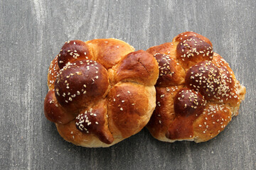Delicious, fluffy and freshly made at home pan de muerto with sesame seeds sprinkled as a Mexican tradition for the Day of All Souls and All Saints which is celebrated in November
