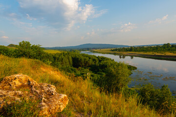 Obraz premium Forest, river and blue sky.