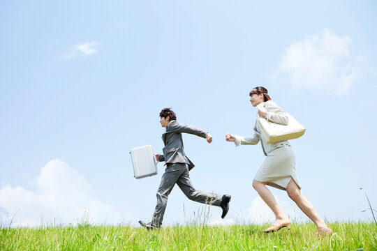 走るビジネスマンとビジネスウーマン