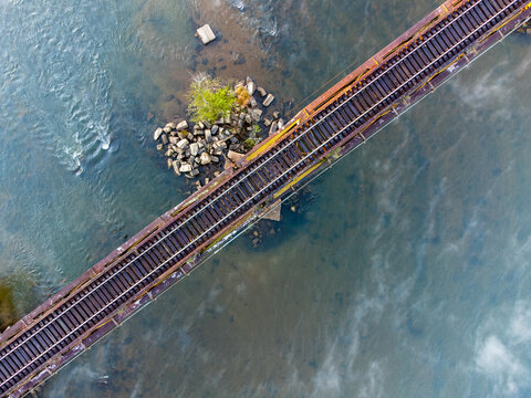 Top down view of railroad trestle over Catawba River in South Carolina, USA with mist rising from water.