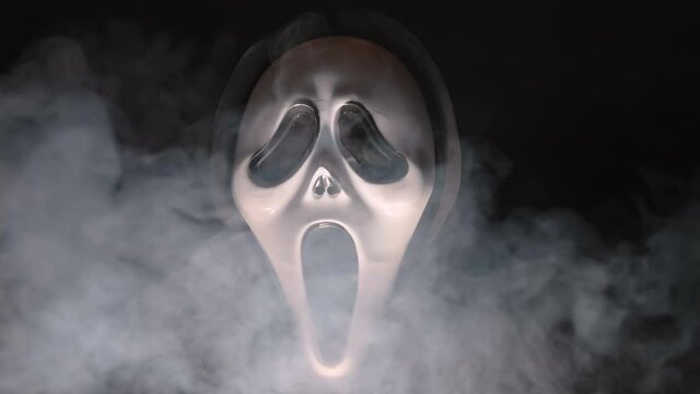White smoke coming out of the spooky ghost mask during the halloween season