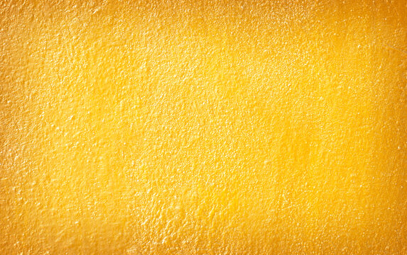 Cement yellow wall plaster and piant rough style, Decorative plaster effect on wall texture abstract background