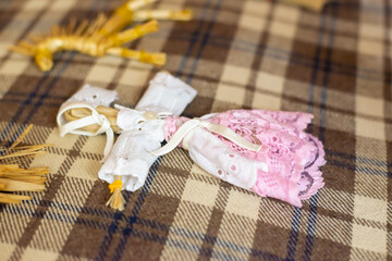 A homemade baby doll lies on a blanket.