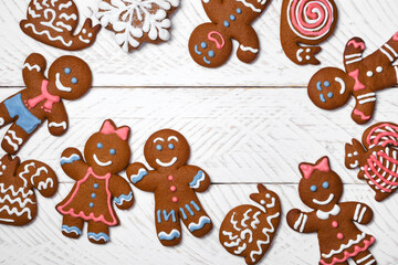 Christmas background with gingerbread men and woman. Top view.  Set of christmas cookies- snails, squirrels, snowflake 