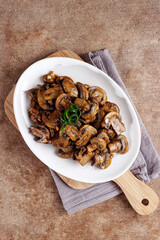 Tumis jamur kancing or Oseng jamur kancing. Mushrooms sauteed in a plate.