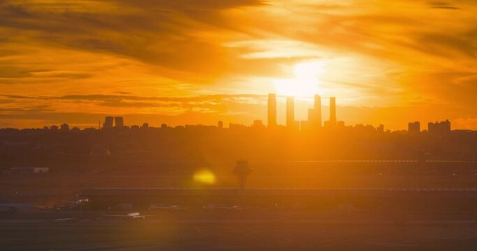 Day to night timelapse Madrid airport and skyline during colorful sunset