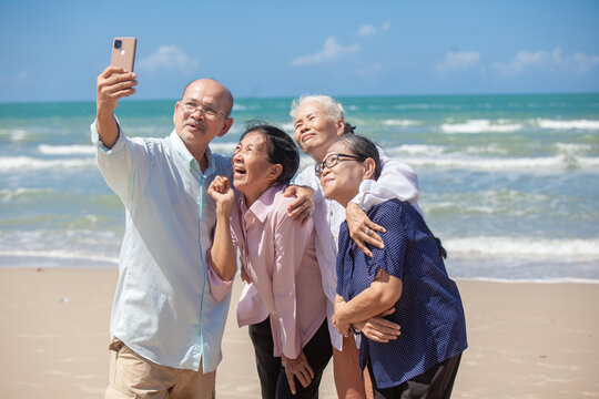 Asian happy family enjoy relaxing on the beach. Happy family taking selfie on sea beach