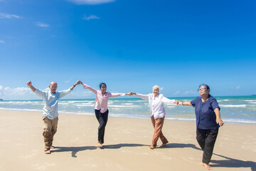Asian Family Having Fun On Beach. Senior Woman On Holiday On Beach. family holiday and travel summer beach concept