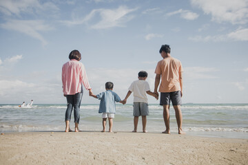 Happy young family Asian have fun on beach. Young family on vacation have a lot of fun