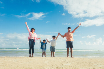 Happy young family Asian have fun on beach. Young family on vacation have a lot of fun