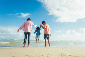 Happy young family Asian have fun on beach. Young family on vacation have a lot of fun