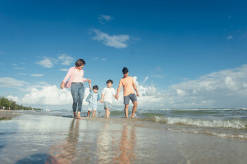 Fototapeta na wymiar Happy young family Asian have fun on beach. Young family on vacation have a lot of fun