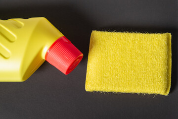 Sponge and dishwashing gel on a dark background.
