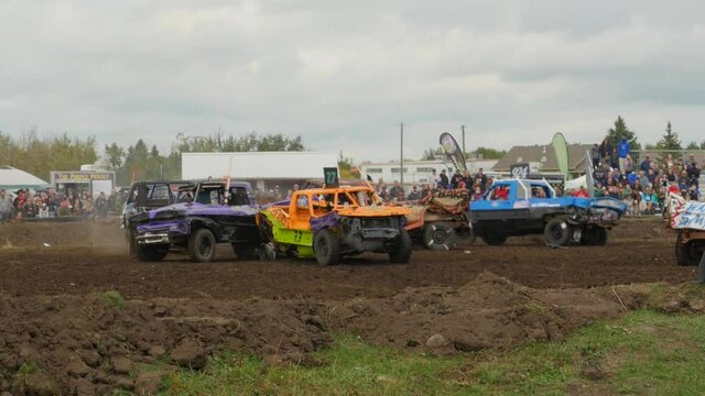 Trucks smashing into each other at demolition derby