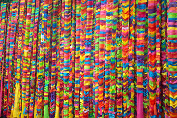 Colorful cloths hanging in Thai temples for Buddhists to write their names for the auspiciousness of life..
