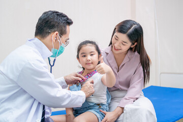 Child girl patient visit doctor with mother, Pediatrician doctor examining little patient using a stethoscope