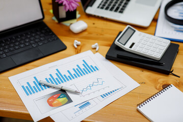 Close up of businesswoman working on desk office with using a calculator to calculate the numbers, finance accounting concept.	