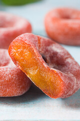 close up of dried persimmon on blue wood background