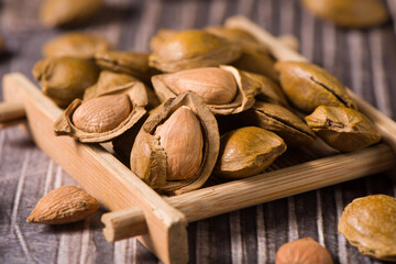 close up of almonds on wood background