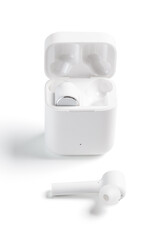  White Wireless Sport Headphones with Charging Box. Wireless in-ear Headphones for Jogging. Close Up View. Isolated on White Background.