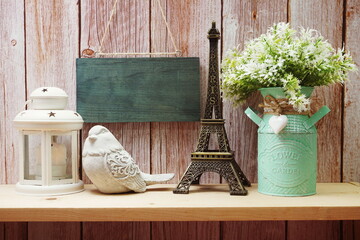 Empty wooden hanging on wooden background with eiffel tower on wooden shelve