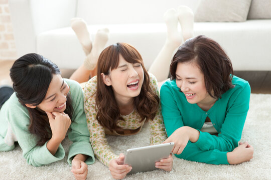 タブレットPCを見る女性3人